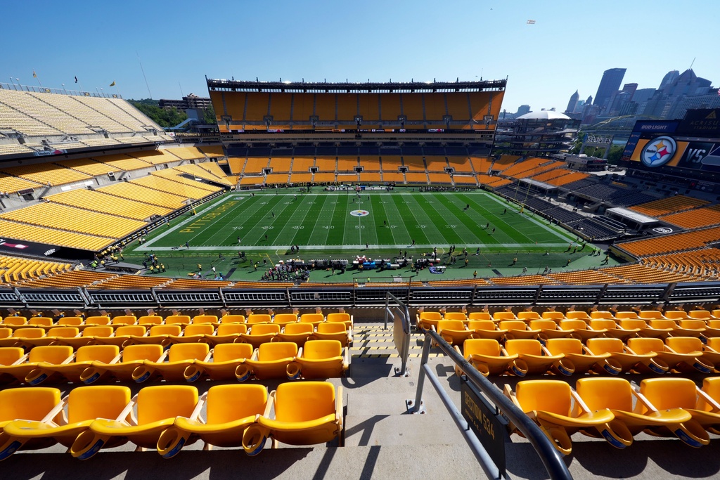 FILE - People stand on the field in Acrisure Stadium before an NFL football game between the Pittsburgh Steelers and the Seattle Seahawks in Pittsburgh, Sept. 14, 2025. (AP Photo/Gene J. Puskar, File)