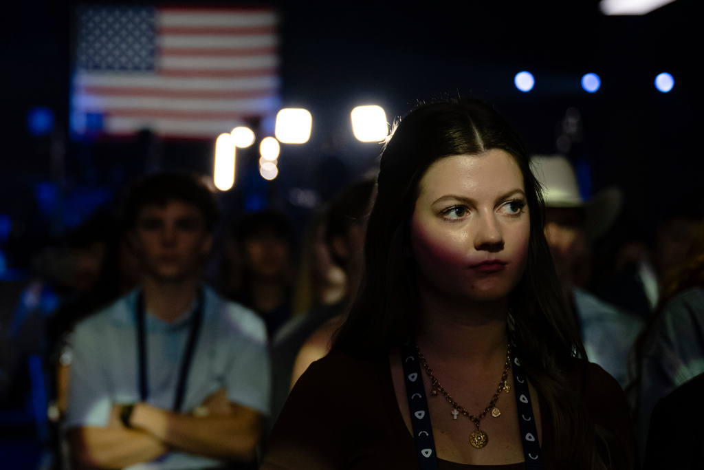 An attendee looks toward the stage during Turning Point USA's AmericaFest 2025, Saturday, Dec. 20, 2025, in Phoenix. (AP Photo/Jon Cherry)