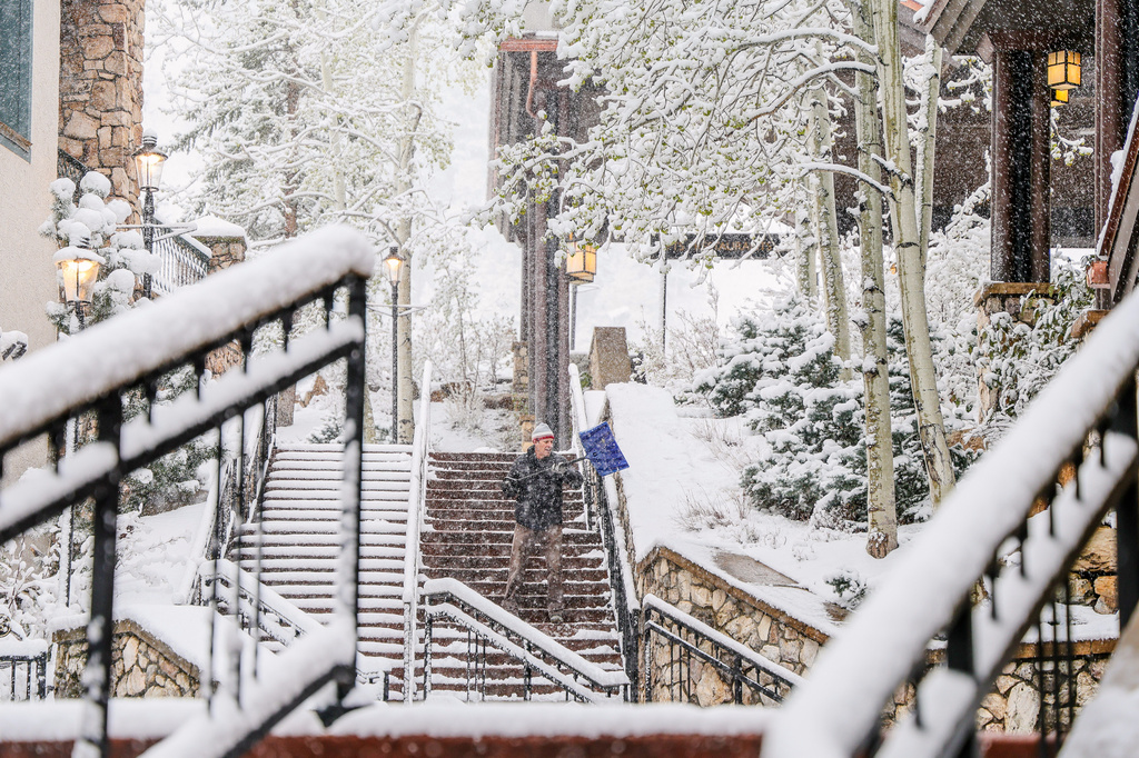 Chris Osborne shovels snow Wednesday, May 6, in Beaver Creek, Colo. (Chris Dillmann/Vail Daily via AP)