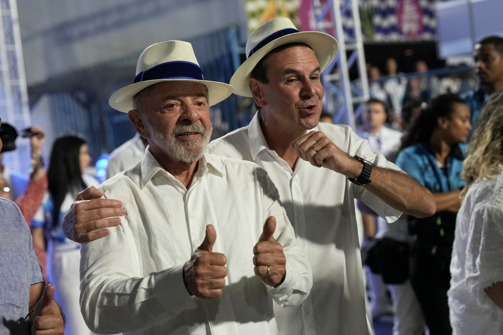Brazilian President Luiz Inacio Lula da Silva, left, and Rio de Janeiro Mayor Eduardo Paes attend the Academicos de Niteroi samba school parade during Carnival celebrations at the Sambadrome, in Rio de Janeiro, Sunday, Feb. 15, 2026. (AP Photo/Silvia Izquierdo)