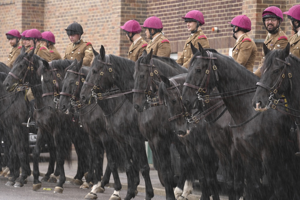 Soldiers of Household Cavalry Mounted Regiment rehearse at preparations for the carriage procession at Combermere Barracks, in Windsor, England, Monday, Sept. 15, 2025, ahead of the state visit of U.S. President Donald Trump. (AP Photo/Kin Cheung)