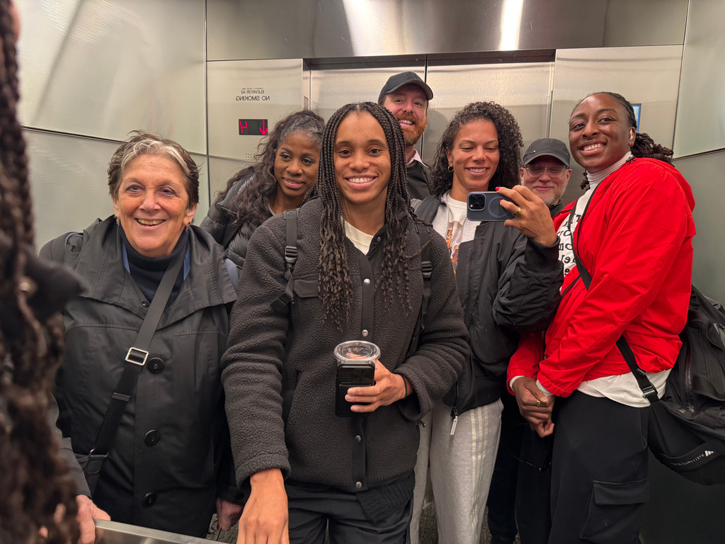 WNBA players and union members pose for a photo in an elevator after a negotiating session at the NBA headquarters on March 13, 2026, in New York. (Alysha Clark via AP)