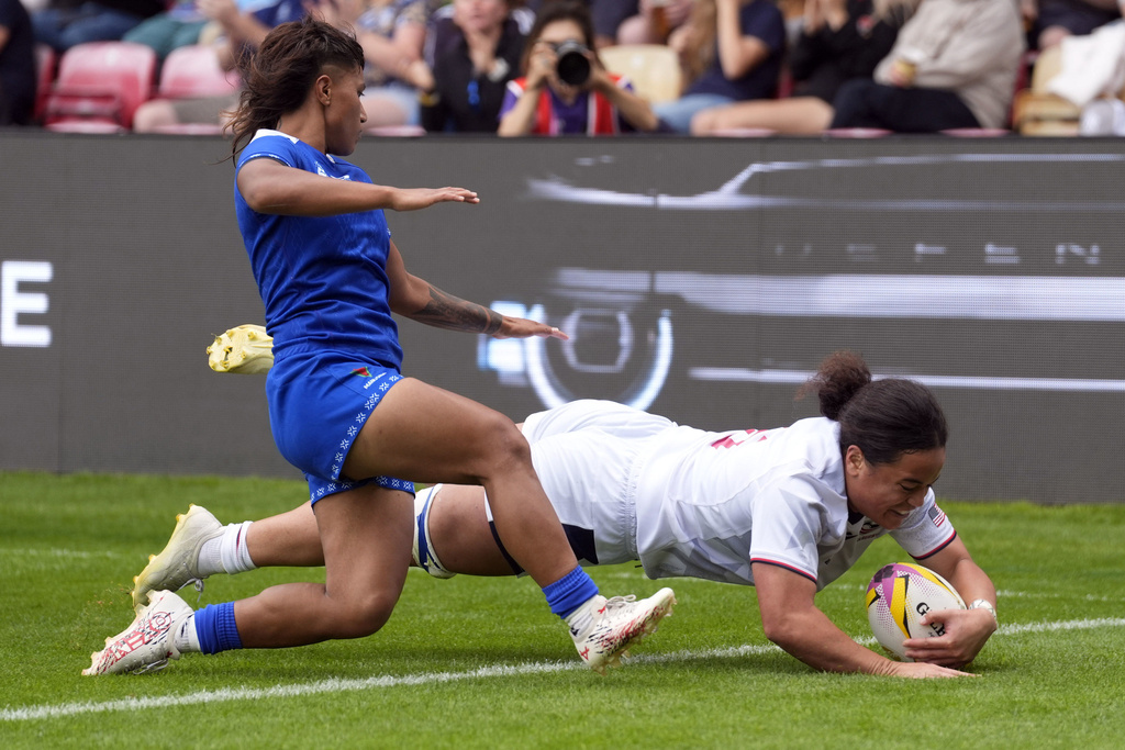 USA's Freda Tafuna, right, scores her sides seventh try of the game during the Women's Rugby World Cup 2025 Pool A match between USA and Samoa in York, England, Saturday, Sept. 6, 2025. (Danny Lawson/PA via AP)