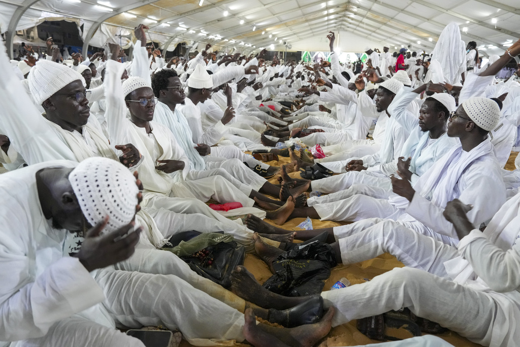 Men sing and gesture as they mark Prophet Muhammad's birthday, known as Mawlid, in Dakar, Senegal, Friday, Sept. 5, 2025. (AP Photo/Misper Apawu)