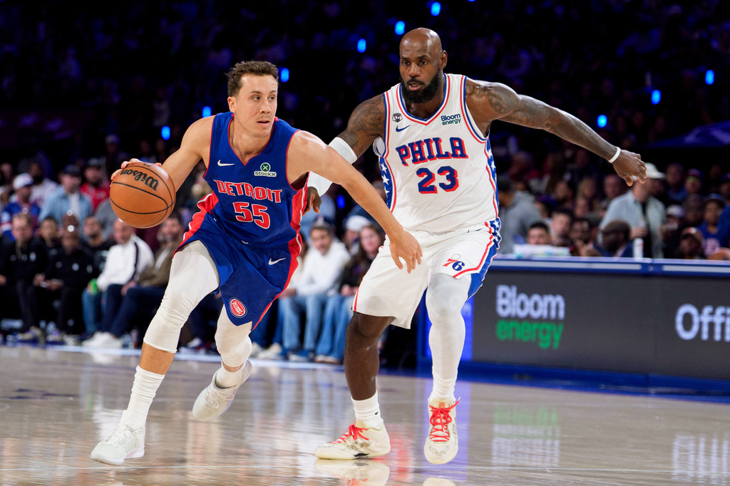 Detroit Pistons' Duncan Robinson, left, drives to the basket against Philadelphia 76ers' LeBron James, right, during the first half of an NBA basketball game, Sunday, Oct. 25, 2026, in Philadelphia. (AP Photo/Chris Szagola)