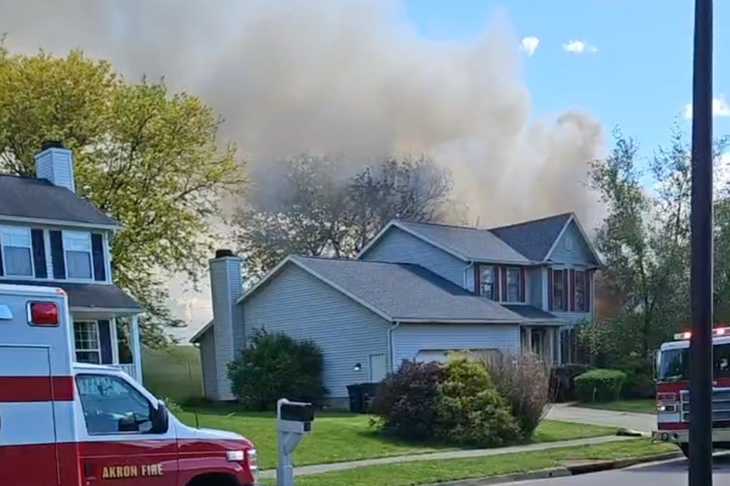 This image taken from video provided by Thomas A. Tatum shows smoke rising after a plane crashed into a house in Akron, Ohio, on Thursday, May 14, 2026. (Thomas A. Tatum via AP)