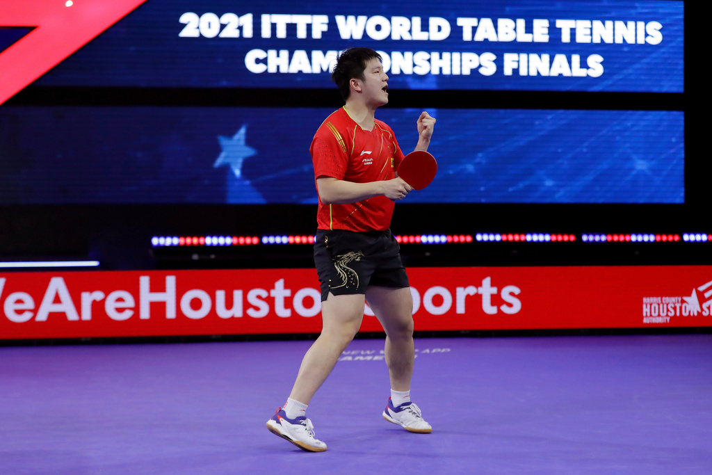FILE - China's Zhendong Fan reacts after winning match point to take the men's singles finals match during the World Table Tennis Championships Monday, Nov. 29, 2021, in Houston. (AP Photo/Michael Wyke, File)