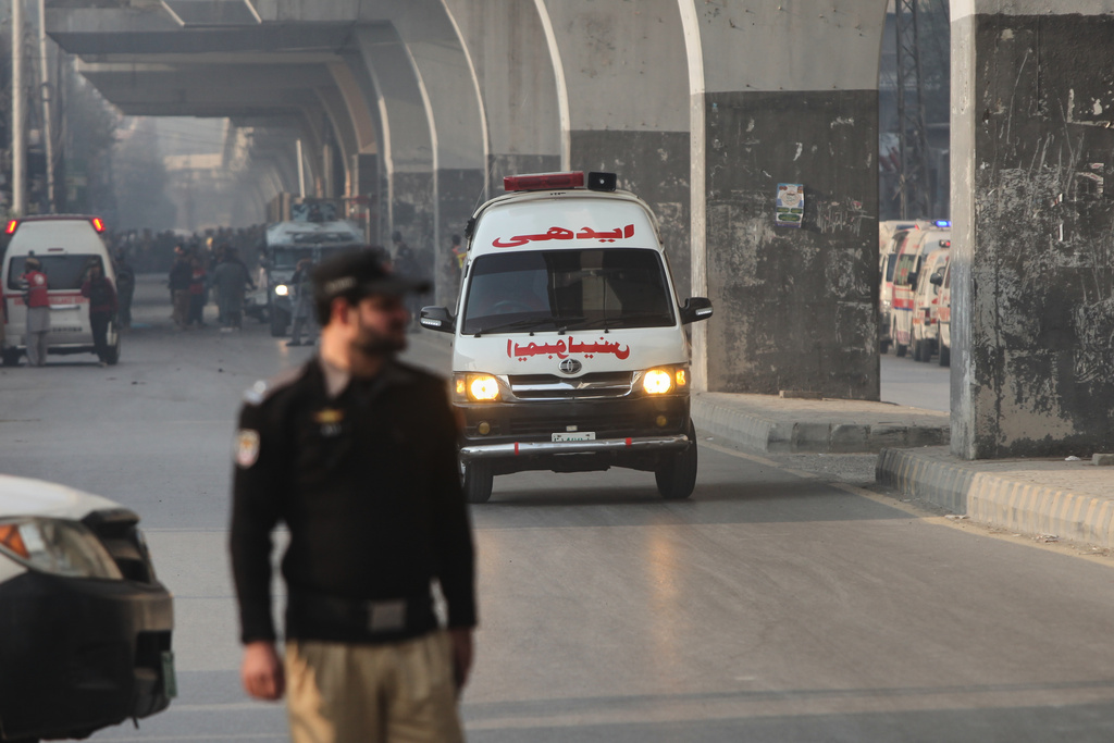 An ambulance carrying injured people drive towards a hospital after suicide bombers attacked the headquarters of the Federal Constabulary (FC), in Peshawar, Pakistan, Monday, Nov. 24, 2025. (AP Photo/Muhammad Zubair)