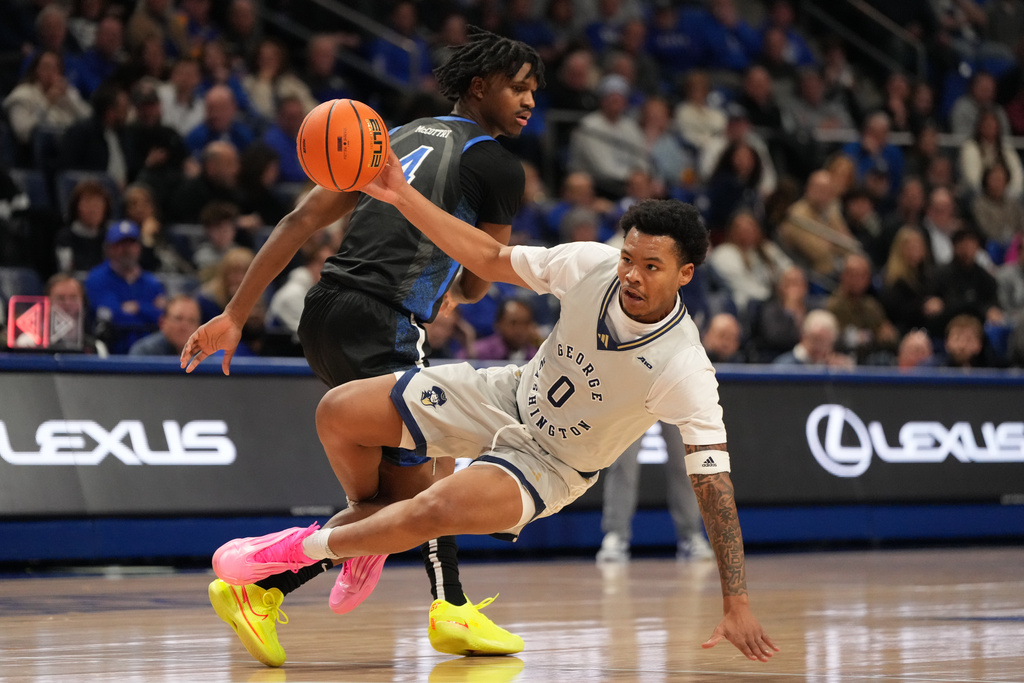 George Washington's Trey Autry (0) falls after being fouled by Saint Louis' Amari McCottry (4) during the second half of an NCAA college basketball game Tuesday, Jan. 27, 2026, in St. Louis. (AP Photo/Jeff Roberson)