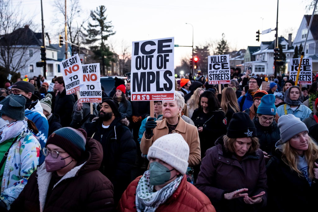 People participate in a protest and vigil after an Immigration and Customs Enforcement officer shot and killed a woman in Minneapolis, on Wednesday, Jan. 7, 2026. (Christopher Katsarov/The Canadian Press via AP)