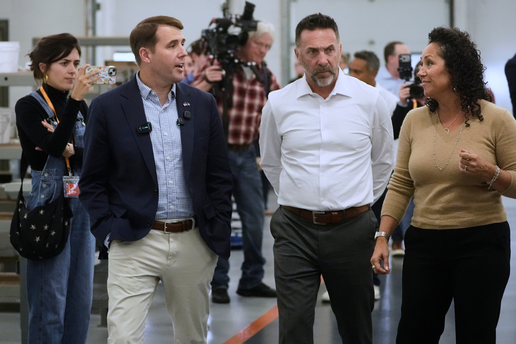 Rep. Chris Pappas, a Democratic candidate for U.S. Senate, left, speaks to Aaron Bagshaw and Adria Bagshaw at the WH Bagshaw company, Tuesday, Sept. 29, 2026, in Salem, N.H. (AP Photo/Robert F. Bukaty)
