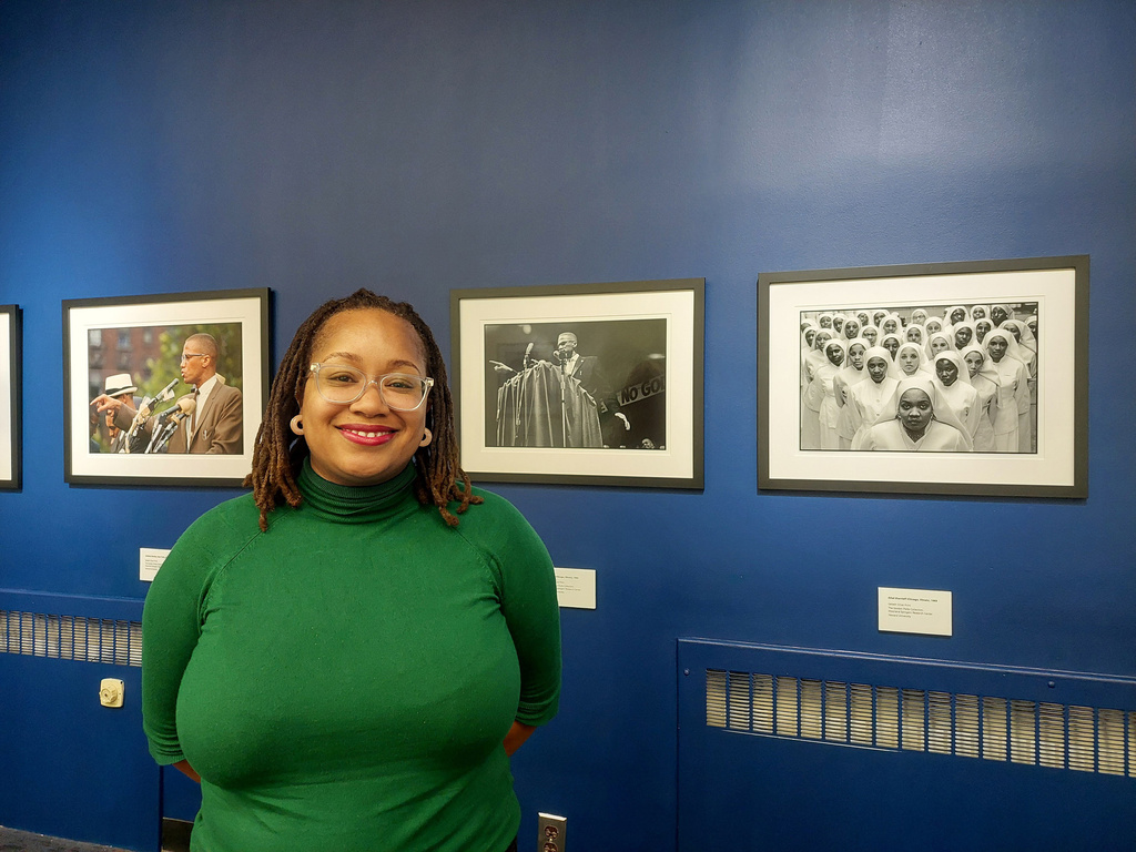 Melanee C. Harvey, the curator of "Temples of Hope, Rituals of Survival: Gordon Parks and Black Religious Life" exhibit poses at the Howard Museum in Washington, D.C. (Adelle M. Banks/Religion News Service via AP)