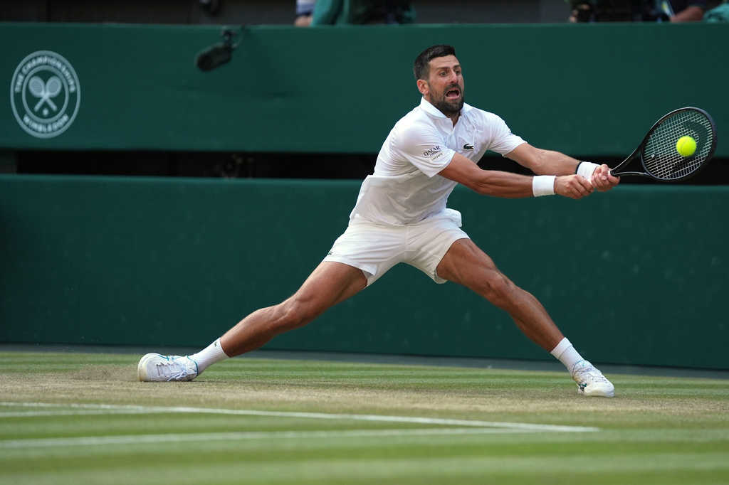 Novak Djokovic of Serbia returns the ball to Felix Auger-Aliassime of Canada in their quarter-final men's singles match at the Wimbledon Tennis Championships in London, Tuesday, July 7, 2026. (AP Photo/Maja Smiejkowska)