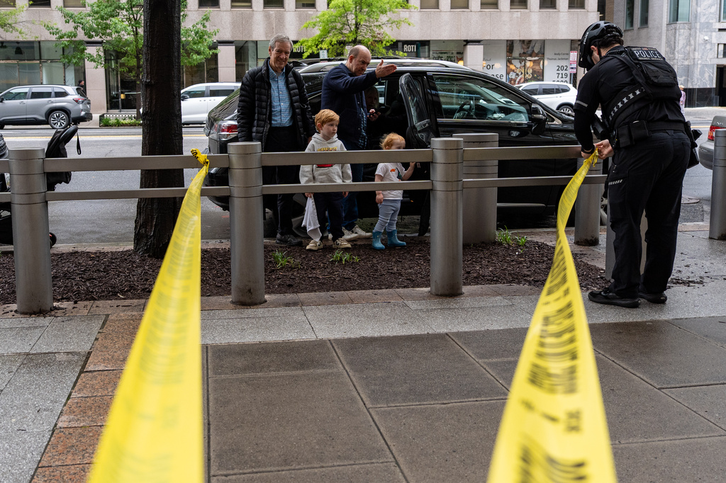 People watch as U.S. Secret Service Police place crime scene tape after a copper jacket of a bullet was found near the scene of a shooting close to the White House, Sunday, May 24, 2026, in Washington. (AP Photo/Alex Brandon)