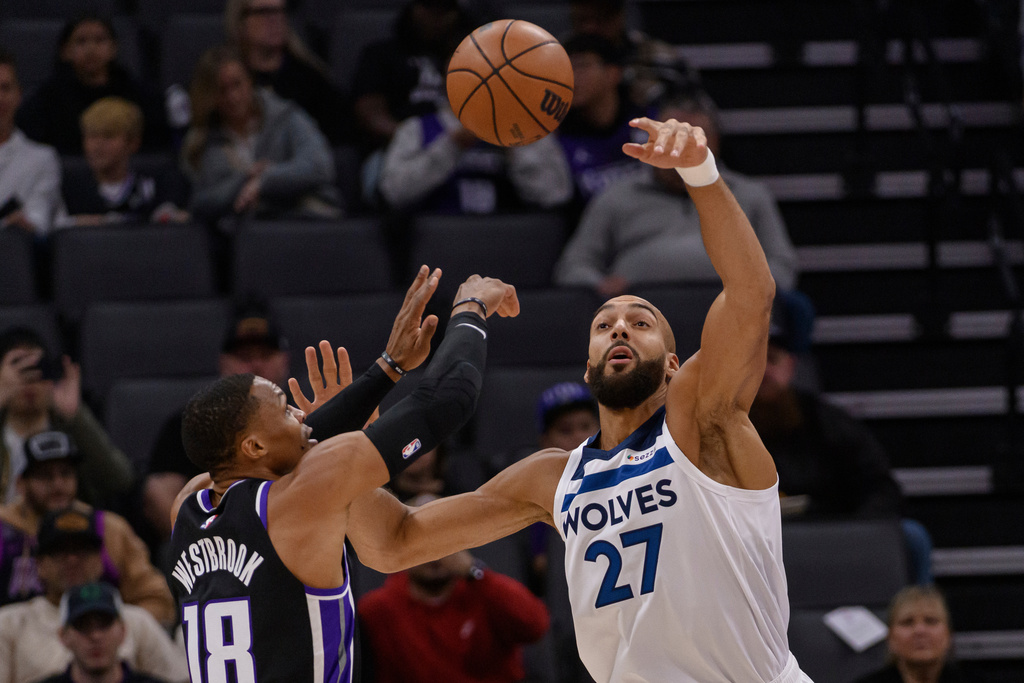 Sacramento Kings guard Russell Westbrook (18) shoots over Minnesota Timberwolves center Rudy Gobert (27) during the first half of an NBA basketball game in Sacramento, Calif., Monday, Nov. 24, 2025. (AP Photo/Randall Benton)