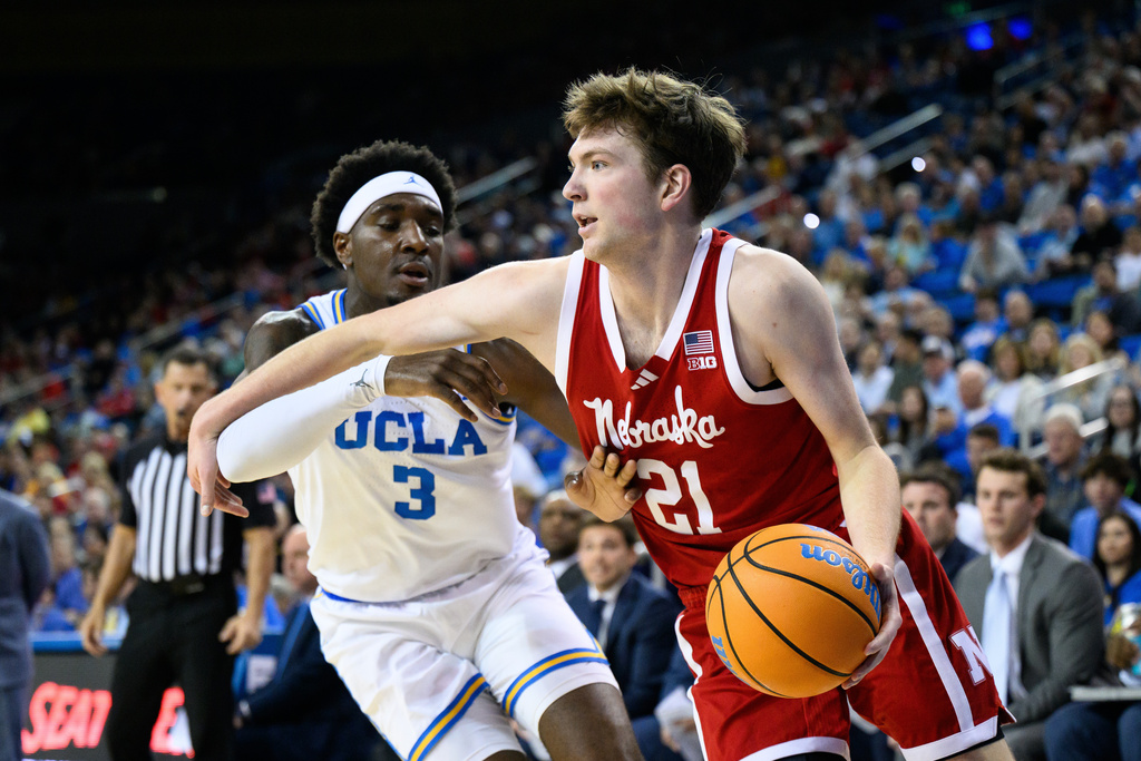 Nebraska forward Pryce Sandfort (21) drives the ball while under pressure from UCLA forward Eric Dailey Jr. (3) during the first half of an NCAA college basketball game Tuesday, March 3, 2026, in Los Angeles. (AP Photo/William Liang)