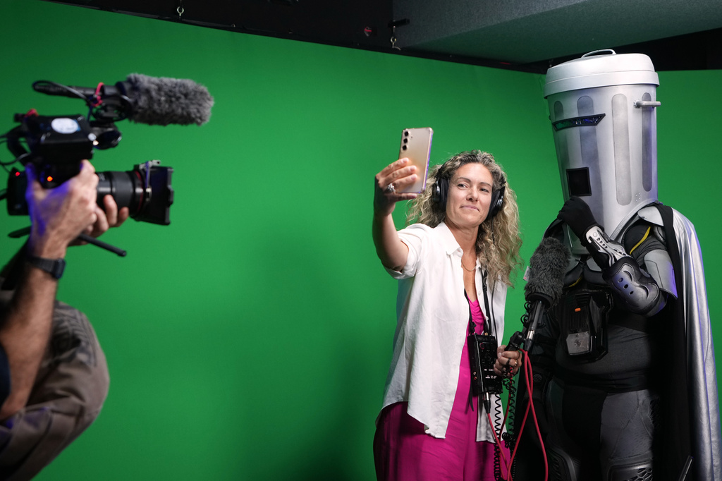 A journalist takes a selfie with Count Binface after he is interviewed at a studio in London ahead of the Clacton by-election, Wednesday, July 29, 2026. (AP Photo/Kirsty Wigglesworth)