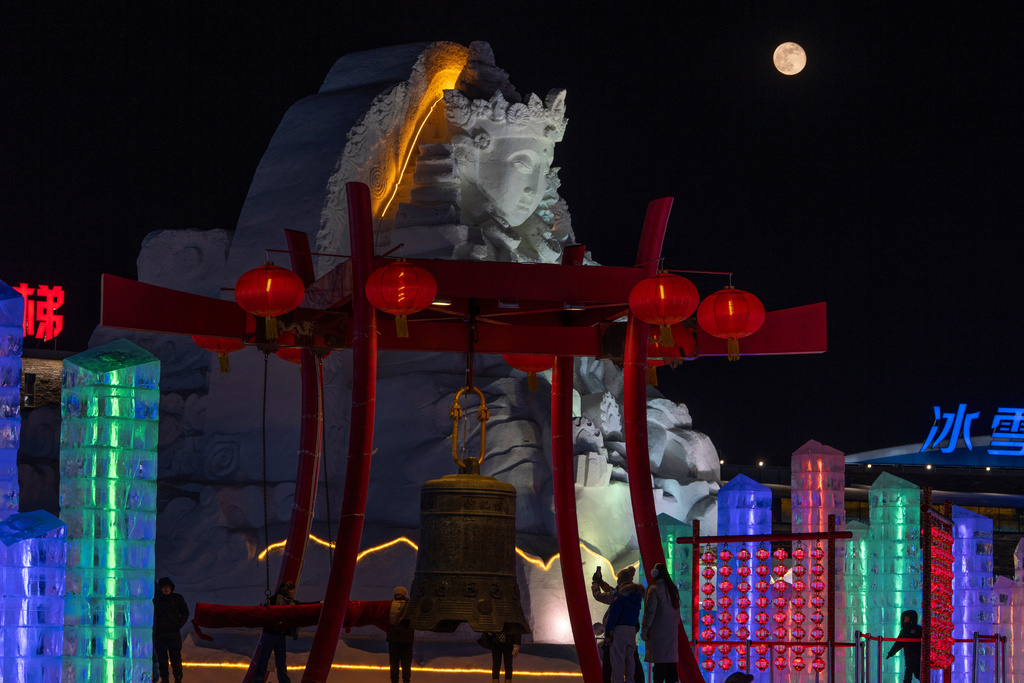 A Wolf Supermoon rises over a snow sculpture at the annual Ice and Snow Festival held in Harbin in northeastern China's Heilongjiang province on Sunday, Jan. 4, 2026. (AP Photo/Ng Han Guan)