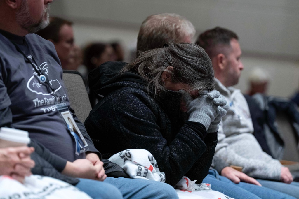People attend the National Transportation Safety Board (NTSB) hearing on the midair aircraft collision that killed 67 people near Washington Reagan National Airport, in Washington, Tuesday, Jan. 27, 2026. (AP Photo/Jose Luis Magana)