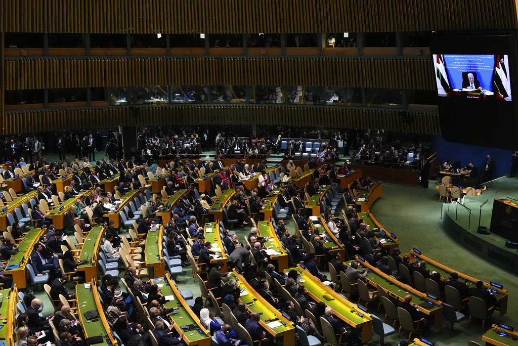 Palestinian President Mahmoud Abbas appears on a screen as he speaks virtually during a high-profile meeting at the United Nations aimed at galvanizing support for a two-state solution to the Israeli-Palestinian conflict Monday, Sept. 22, 2025, at UN headquarters (AP Photo/Yuki Iwamura)
