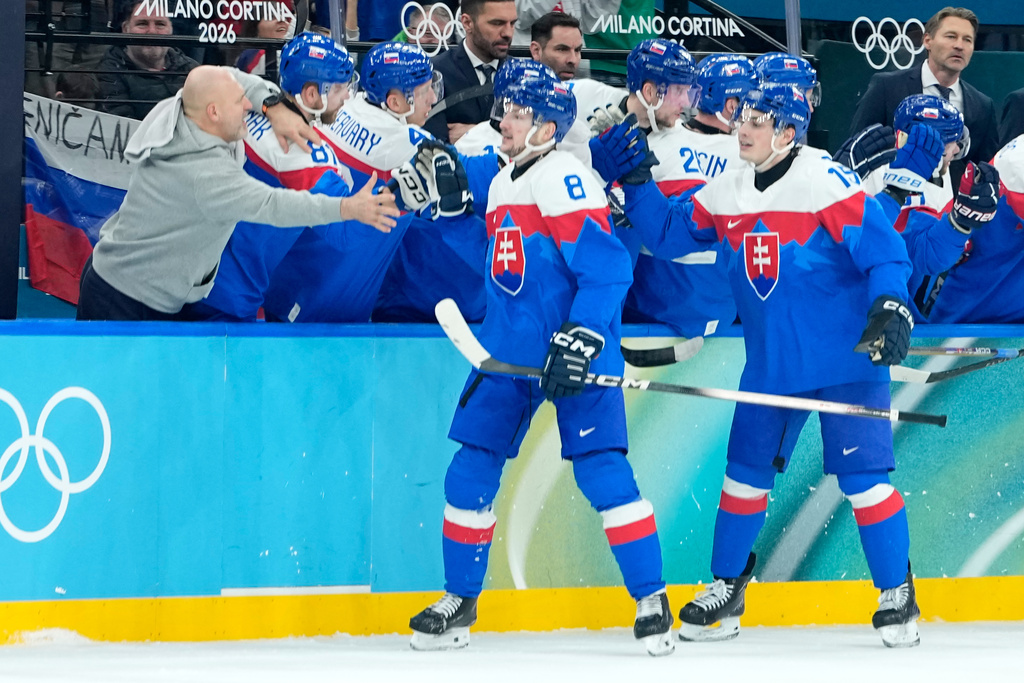 Slovakia's Oliver Okuliar (8) and Slovakia's Dalibor Dvorsky (15) celebrate their side's third goal during a men's ice hockey quarterfinal game between Slovakia and Germany at the 2026 Winter Olympics, in Milan, Italy, Wednesday, Feb. 18, 2026. (AP Photo/Petr David Josek)