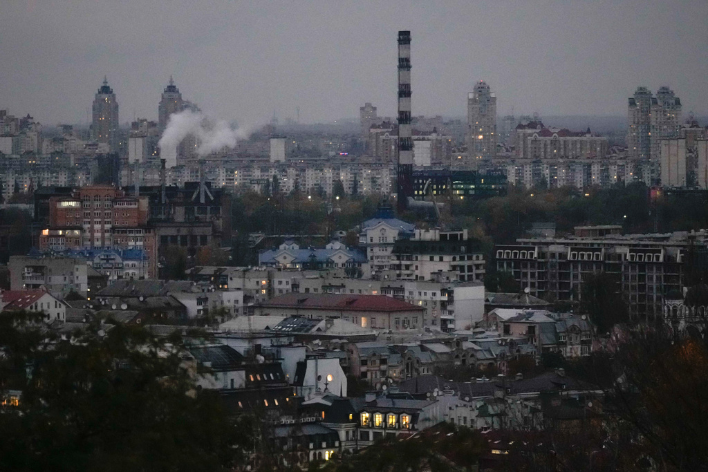 Smoke bellows in the background at dusk in Kyiv, Ukraine, Tuesday, Oct. 21, 2025. (AP Photo/Julia Demaree Nikhinson)