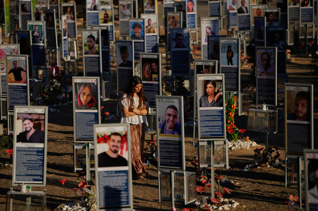 People mark the third anniversary of the Oct. 7, 2023, Hamas attack on Israel at the site of the Nova music festival, where hundreds of revelers were killed and abducted, near Kibbutz Reim, southern Israel, Wednesday, Oct. 7, 2026. (AP Photo/Ohad Zwigenberg)