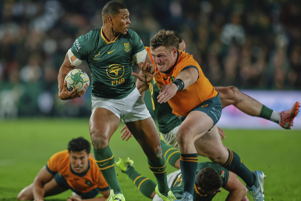 South Africa's Damian Willemse, left, is tackled by Australia's Max Jorgensen during a rugby championship test match between South Africa and Australia, at Ellis Park stadium in Johannesburg, South Africa, Saturday, Aug. 16, 2025. (AP Photo/Frans Lombard)