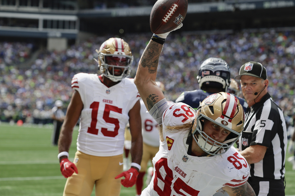San Francisco 49ers tight end George Kittle (85) celebrates after scoring a touchdown during the first half of an NFL football game against the Seattle Seahawks, Sunday, Sept. 7, 2025, in Seattle. (AP Photo/John Froschauer)