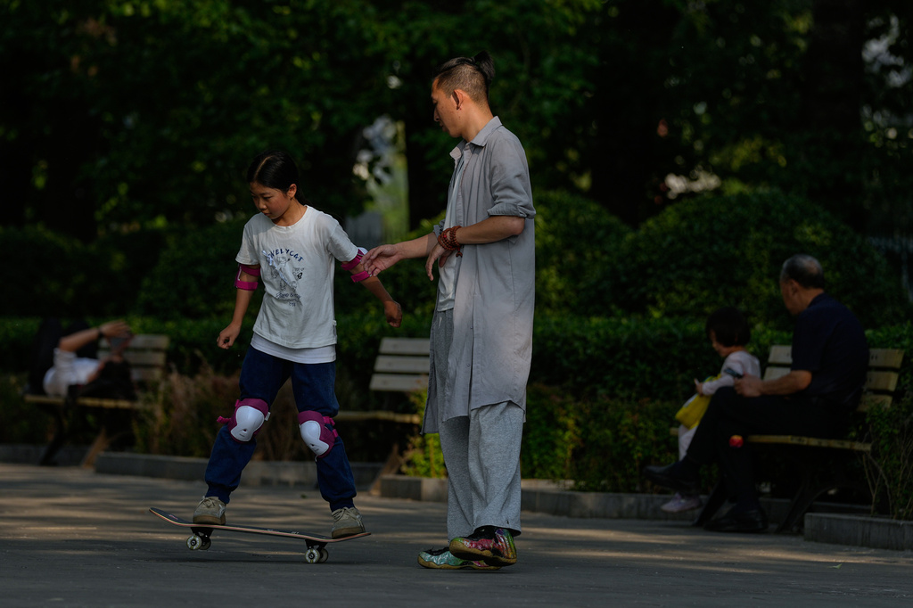 A child practices skateboarding at a public park near a residential complex, in Beijing, Tuesday, May 12, 2026. (AP Photo/Andy Wong)