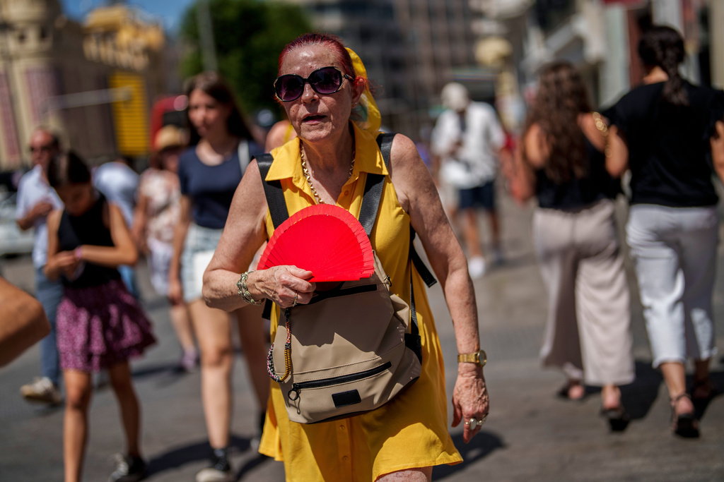 FILE - A woman fans herself in Madrid, Spain, July 10, 2023. (AP Photo/Manu Fernandez, File)
