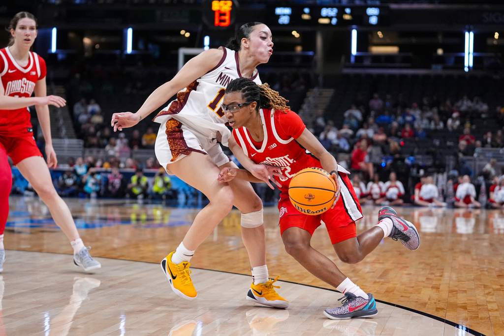 Ohio State guard Jaloni Cambridge (22) drives on Minnesota guard Brylee Glenn (12) in the first half of an NCAA college basketball game in the quarterfinals of the Big Ten Conference tournament, Friday, March 6, 2026 in Indianapolis. (AP Photo/Michael Conroy)