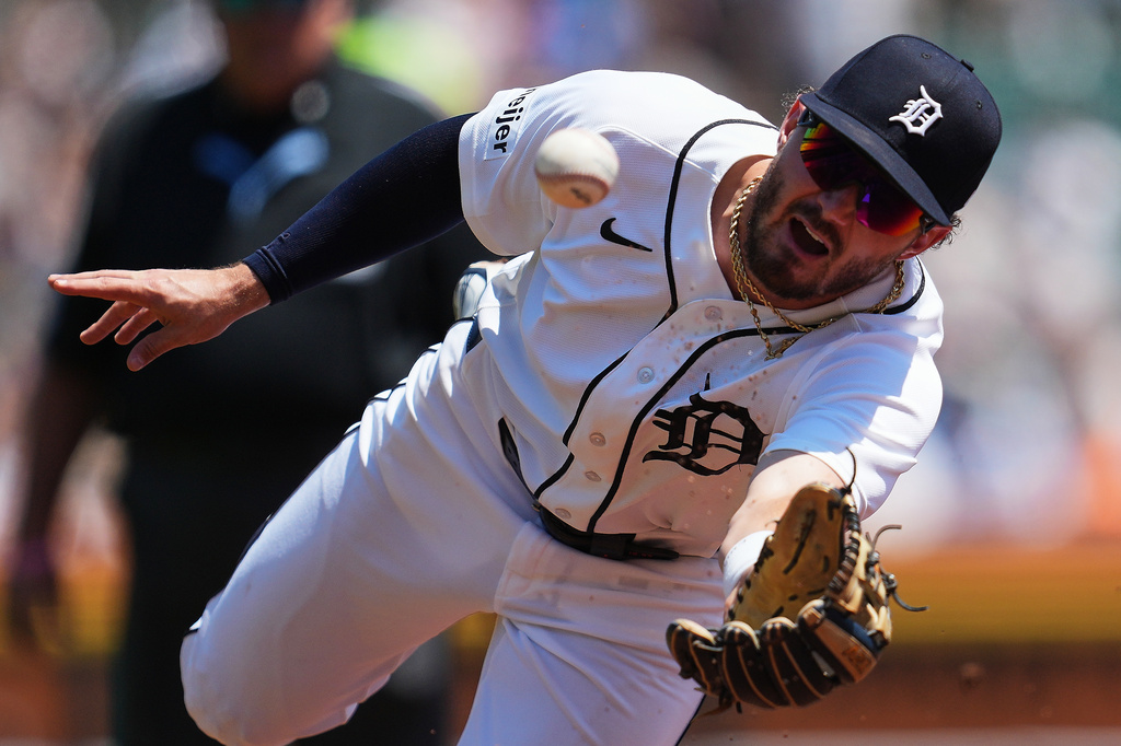 Detroit Tigers second baseman Zach McKinstry flips the ball to first base for an out on a Philadelphia Phillies' Bryce Harper ground ball during the third inning Sunday, July 12, 2026, in Detroit. (AP Photo/Paul Sancya)