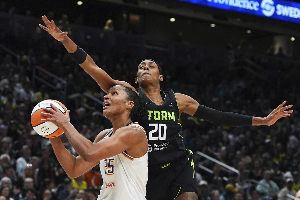 Seattle Storm guard Brittney Sykes (20) fouls Phoenix Mercury forward Alyssa Thomas, left, near the basket during the first half of a WNBA basketball game Sunday, Aug. 17, 2025, in Seattle. (AP Photo/Lindsey Wasson)