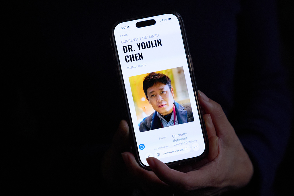 Yufang Rong, wife of U.S. citizen Youlin Chen, who she says has been wrongfully detained in China, holds a photograph of him as seen on a website about detainees on her phone, Tuesday, Sept. 22, 2026, in Washington. (AP Photo/Jacquelyn Martin)