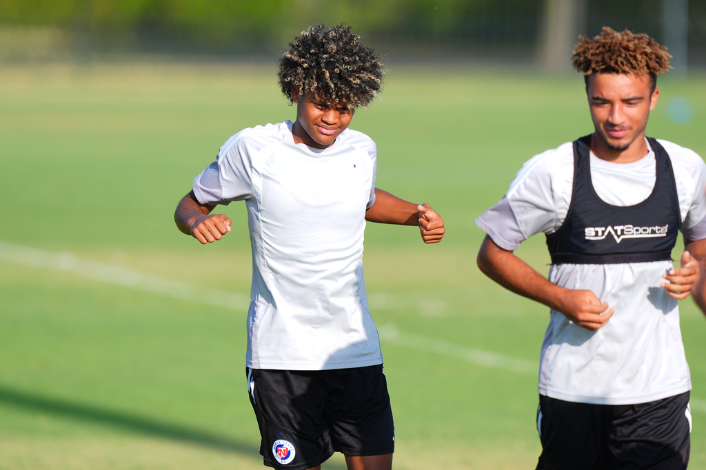 Benji Flowers, left, stretches during a FC Dallas Academy soccer training session in Frisco, Texas, Friday, Aug. 14, 2026. (AP Photo/LM Otero)