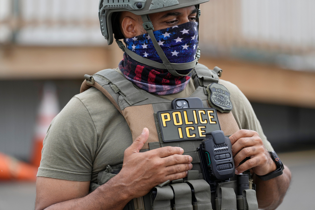 A masked ICE agent stands outside the Delaney Hall detention center during a protest against the transfer of detainees on Wednesday, May 27, 2026, in Newark, N.J. (AP Photo/Seth Wenig)