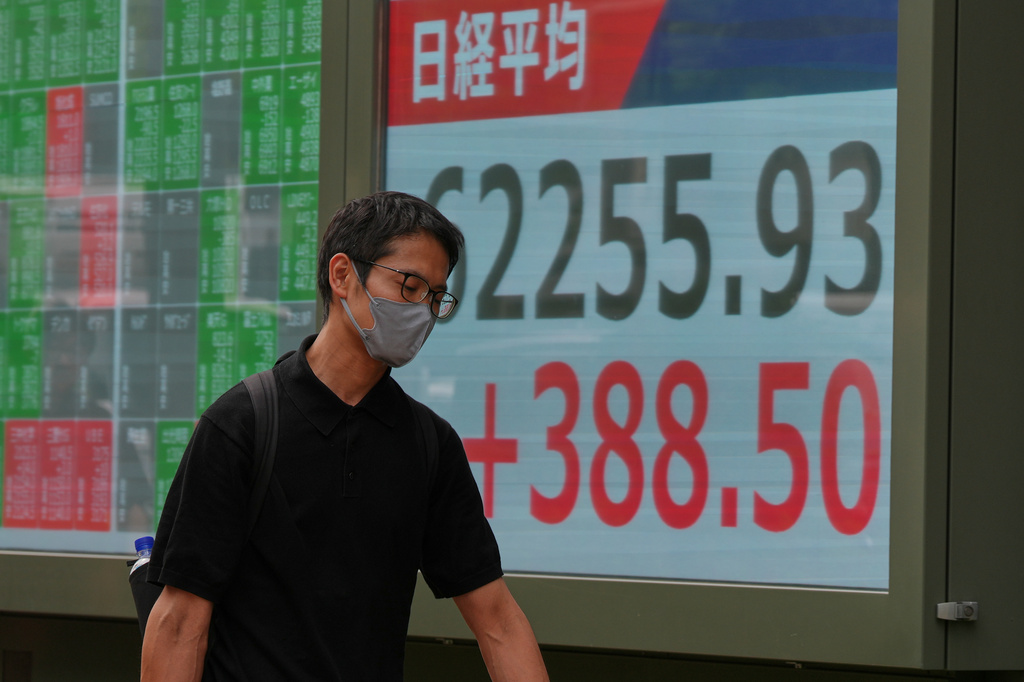 A person walks past an electronic board showing Japan's Nikkei index at a securities firm Friday, July 31, 2026. (AP Photo/Eugene Hoshiko)