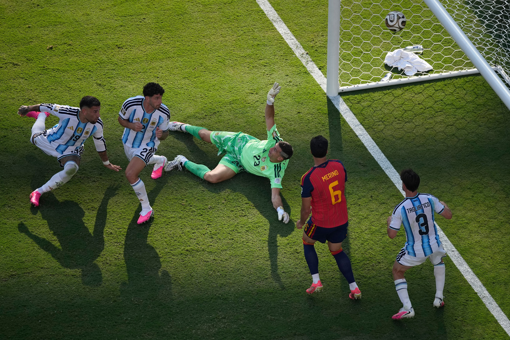 Argentina goalkeeper Emiliano Martinez (23) fails to save a shot by Spain's Ferran Torres (7) who scored their opening goal during the World Cup final soccer match between Spain and Argentina in East Rutherford, N.J., near New York, Sunday, July 19, 2026. (AP Photo/Matt Slocum)