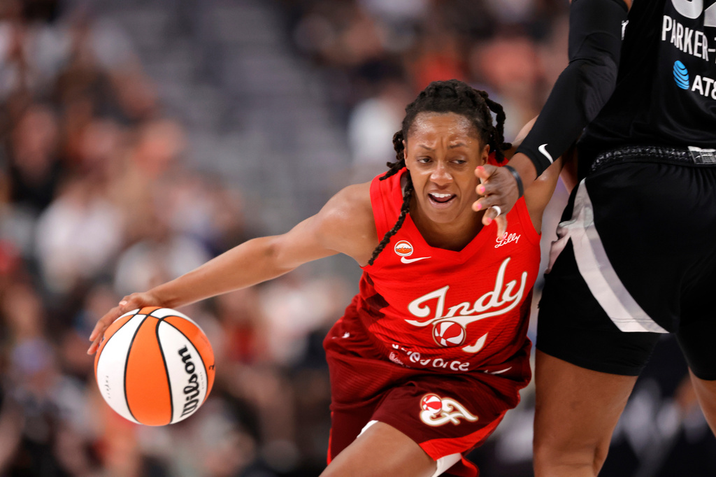 Indiana Fever guard Kelsey Mitchell (0) drives against Las Vegas Aces forward Cheyenne Parker-Tyus (32) during the first half of an WNBA basketball game Sunday, July 5, 2026, in Las Vegas. (Steve Marcus/Las Vegas Sun via AP)