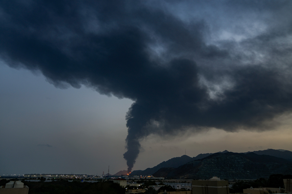 FILE - Fire and a plume of smoke is visible after, according to authorities, debris of an Iranian intercepted drone hit the Fujairah oil facility, in Fujairah, United Arab Emirates, March 3, 2026. (AP Photo/Altaf Qadri)