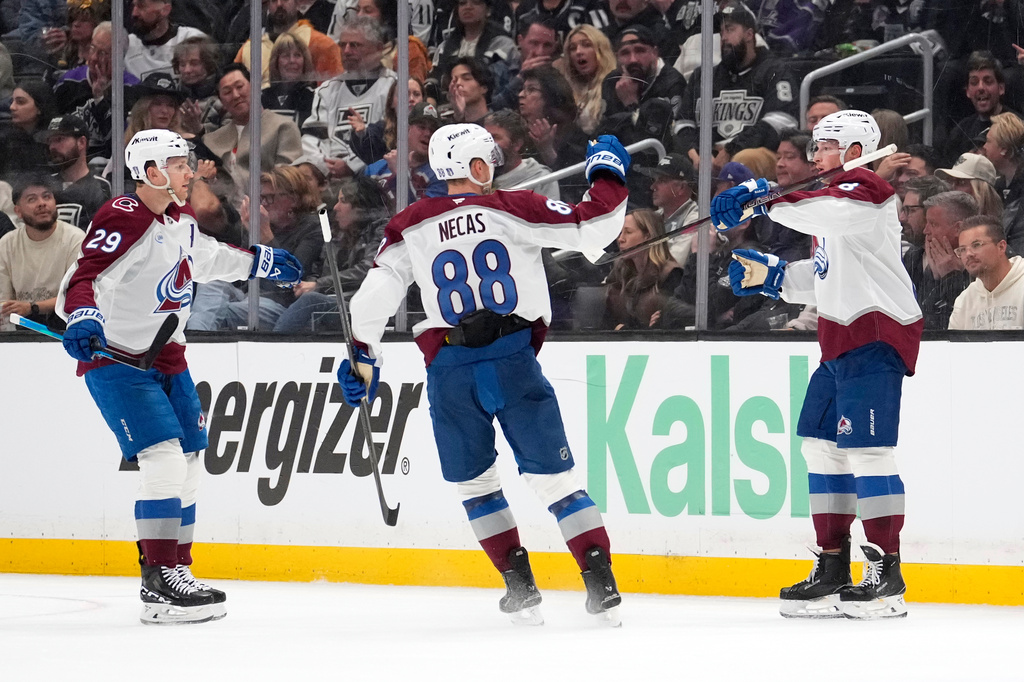 Colorado Avalanche defenseman Cale Makar, right, celebrates his goal with center Nathan MacKinnon, left, and center Martin Necas during the second period of Game 3 in the first round of the NHL hockey Stanley Cup playoffs against the Los Angeles Kings, Thursday, April 23, 2026, in Los Angeles. (AP Photo/Mark J. Terrill)