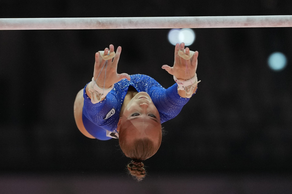 Individual Neutral Athlete Angelina Melnikova competes on the uneven bars during the 53rd Artistic Gymnastics World Championships in Jakarta, Indonesia, Tuesday, Oct. 21, 2025. (AP Photo/Dita Alangkara)