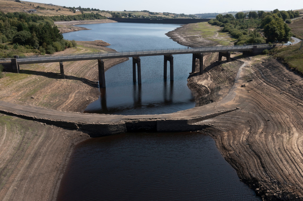 With more than two-thirds of the UK under drought conditions the historic packhorse bridge at Baitings Reservoir near Sowerby Bridge is exposed as water levels drop throught the country, in Sowerby Bridge, England, Thursday, Aug. 13, 2026. (AP Photo/Jon Super)