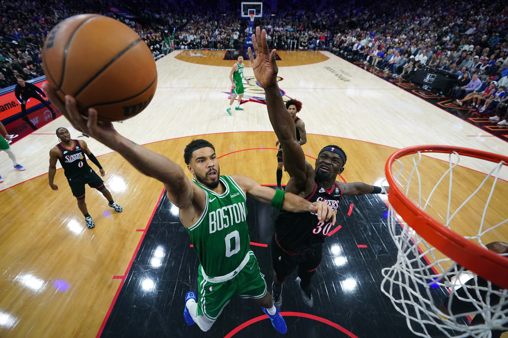 Boston Celtics' Jayson Tatum, left, goes up for a shot against Philadelphia 76ers' Adem Bona during the second half of Game 3 in a first-round NBA playoffs basketball series Friday, April 24, 2026, in Philadelphia. (AP Photo/Matt Slocum)