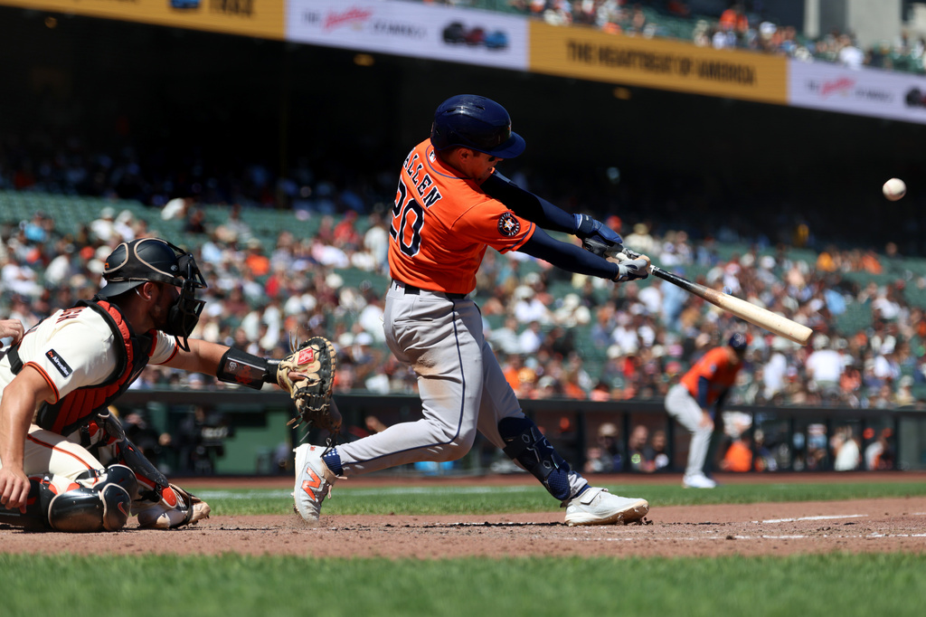 Houston Astros' Nick Allen (20) hits an RBI sacrifice fly in front of San Francisco Giants catcher Drew Cavanaugh, left, during the eighth inning of a baseball game in San Francisco, Wednesday, Aug. 12, 2026. (AP Photo/Jed Jacobsohn)