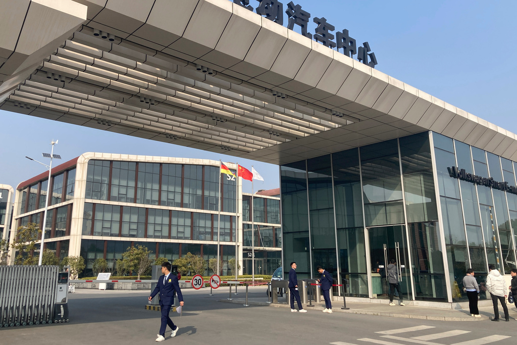 People pass by the entrance to Volkswagen (China) Technology Company, a 3 billion euros ($3.5 billion) R&D center in Hefei in eastern China's Anhui province, on Feb. 25, 2025. (AP Photo/Ken Moritsugu)