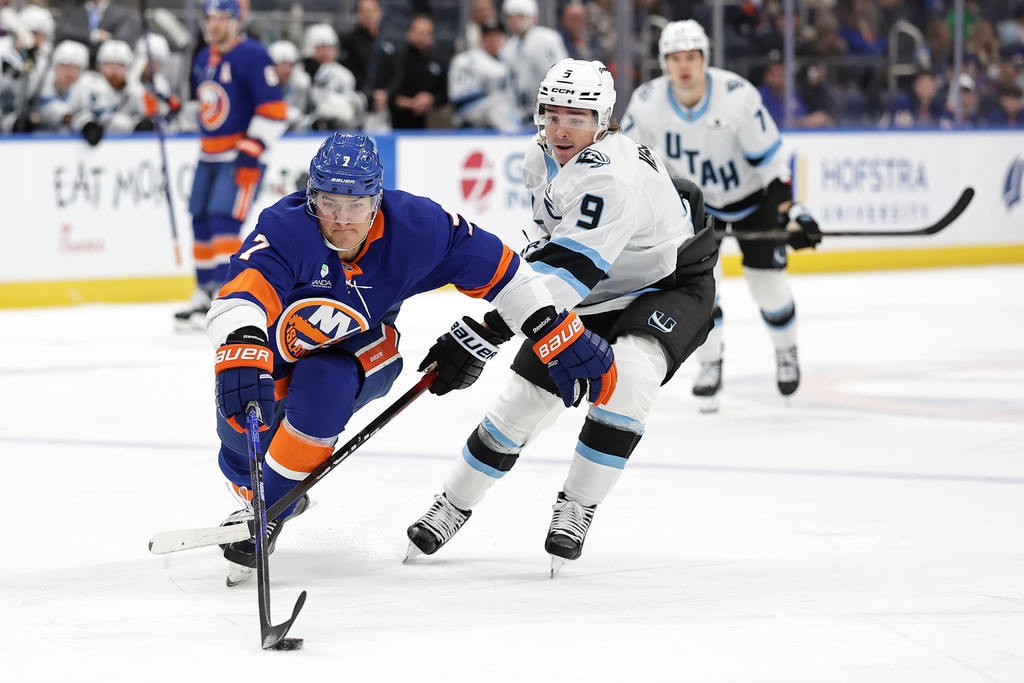 New York Islanders right wing Maxim Tsyplakov (7) controls the puck past Utah Mammoth right wing Clayton Keller (9) in the second period of an NHL hockey game, Thursday, Jan. 1, 2026, in Elmont, N.Y. (AP Photo/Adam Hunger)