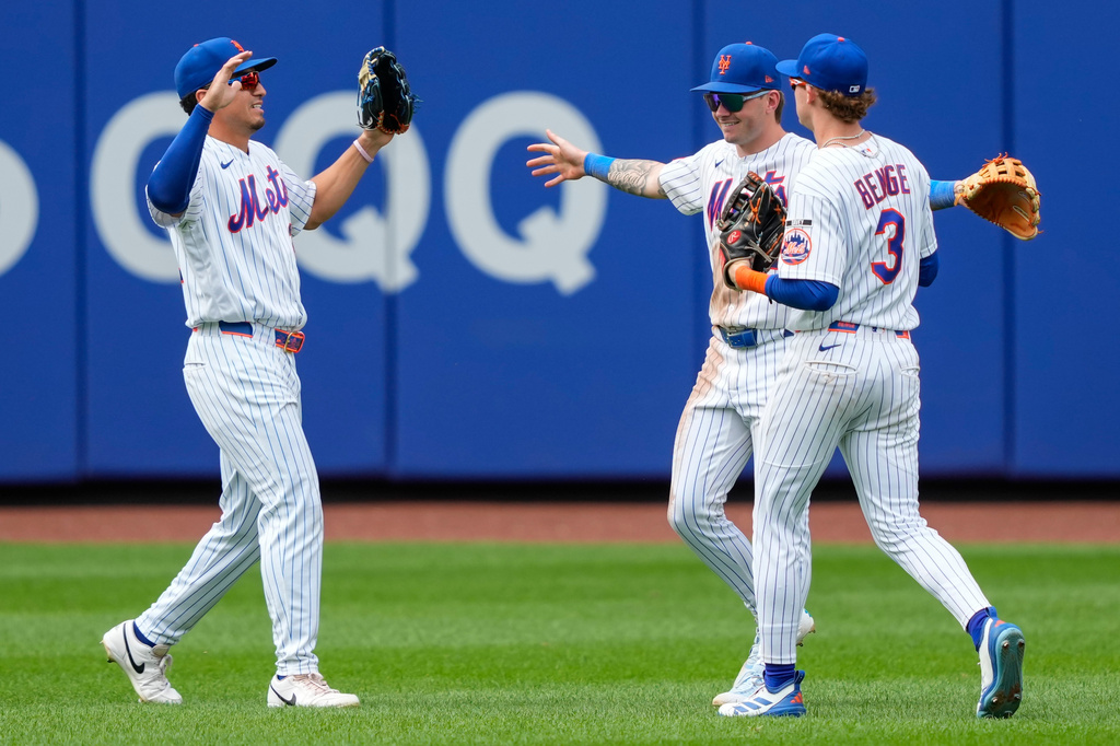 New York Mets right fielder Carson Benge, right, center fielder A.J. Ewing, center, and left fielder Tyrone Taylor, left, celebrate after winning the first baseball game of a doubleheader against the Atlanta Braves, Wednesday, July 29, 2026, in New York. (AP Photo/Yuki Iwamura)