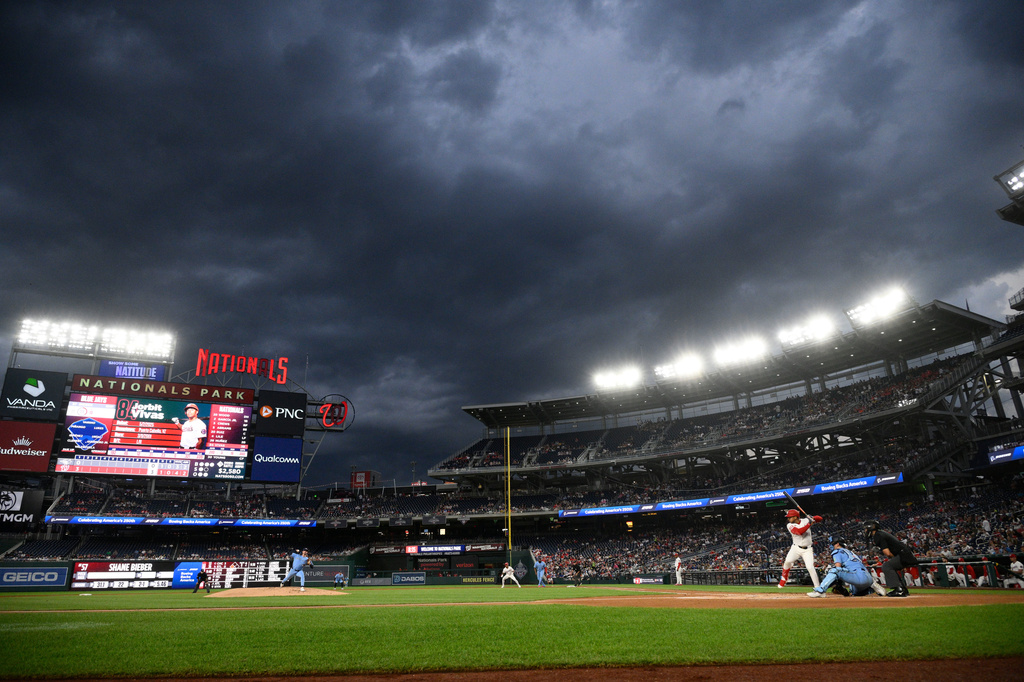 Toronto Blue Jays pitcher Shane Bieber, left, throws to Washington Nationals' Jorbit Vivas, right, during the first inning of a baseball game, Tuesday, July 28, 2026, in Washington. (AP Photo/Nick Wass)